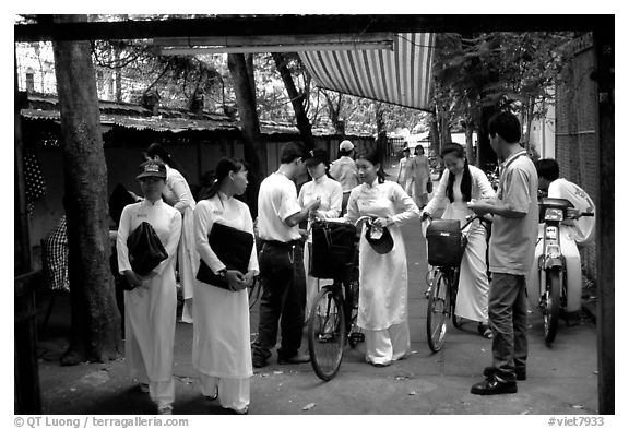 Uniformed school girls exit school. Ho Chi Minh City, Vietnam