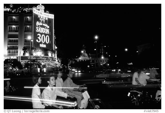 Night traffic in front of a sign celebrating the 300 years of Saigon. Ho Chi Minh City, Vietnam