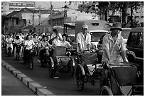 Cyclos and morning traffic. Ho Chi Minh City, Vietnam ( black and white)