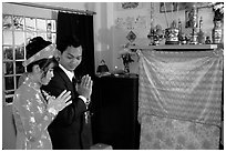 Newly-wed couple prays at the groom's ancestral altar. Ho Chi Minh City, Vietnam (black and white)