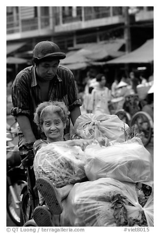 Elderly woman back from the market with plenty of groceries makes good use of cyclo. Cholon, Ho Chi Minh City, Vietnam (black and white)