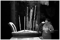 Offering incense at a Chinese temple in Cho Lon. Cholon, District 5, Ho Chi Minh City, Vietnam ( black and white)