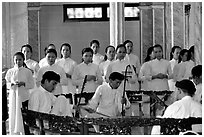Traditional musicians during the noon ceremony. Tay Ninh, Vietnam (black and white)