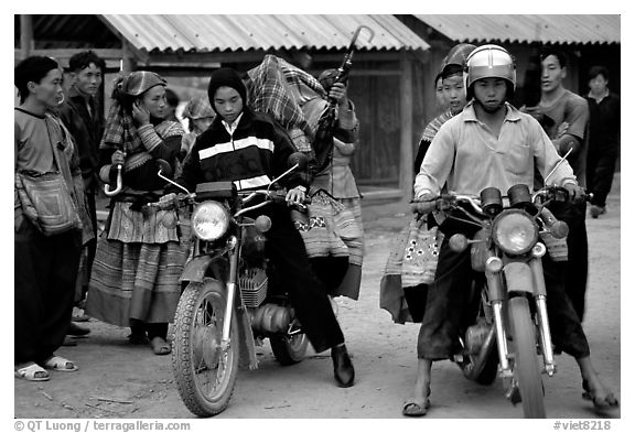 Flower Hmong women getting a ride on all-terrain russian-made motorbikes to the sunday market. Bac Ha, Vietnam (black and white)