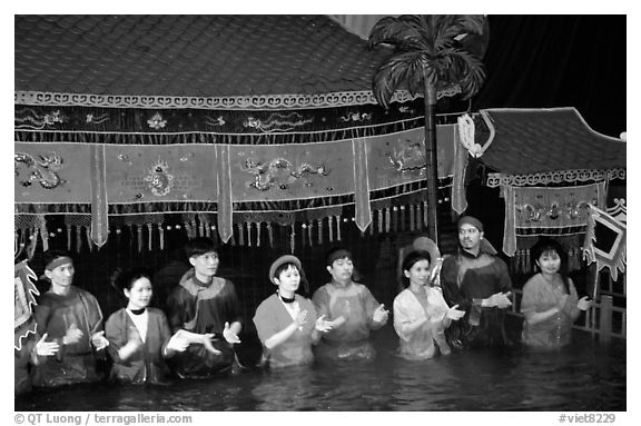 Artists salute after a water puppets performance in 1999. Hanoi, Vietnam (black and white)