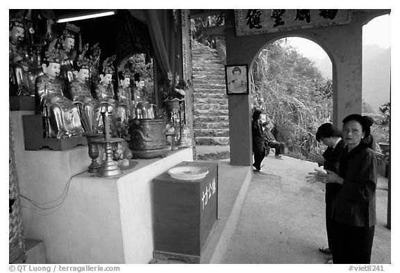 Praying at an outdoor temple. Perfume Pagoda, Vietnam (black and white)