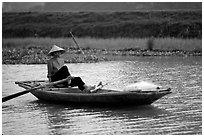 The local technique of paddling with feet, Ken Ga canal. Ninh Binh,  Vietnam (black and white)