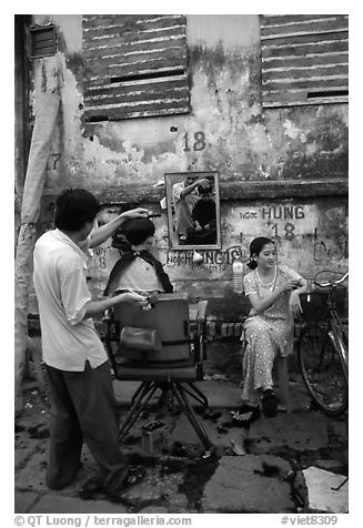 Hairdressing in the street. Ho Chi Minh City, Vietnam (black and white)