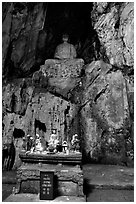 Altar and Buddha statue in a troglodyte sanctuary of the Marble Mountains. Da Nang, Vietnam ( black and white)