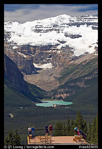 Tourists at observation platform, looking at  Lake Louise and  Victoria Peak. Banff National Park, Canadian Rockies, Alberta, Canada (color)