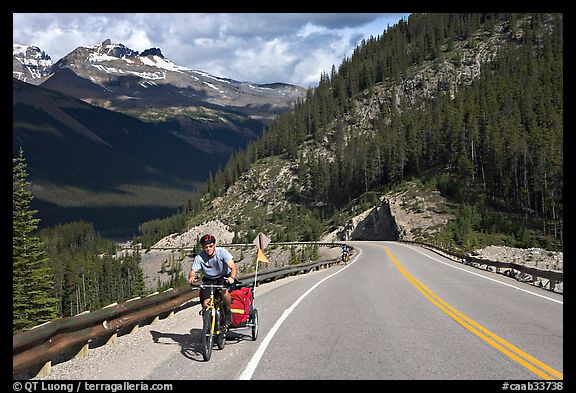 Cyclist with tow, Icefieds Parkway. Jasper National Park, Canadian Rockies, Alberta, Canada (color)