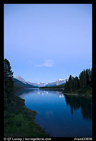Maligne Lake from the outlet of the Maligne River, blue dusk. Jasper National Park, Canadian Rockies, Alberta, Canada