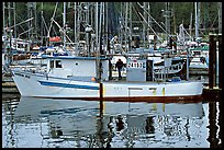 Fishing boat and reflections in harbor, Uclulet. Vancouver Island, British Columbia, Canada (color)