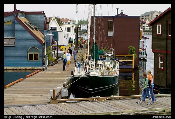 Houseboats, deck, and sailboat, Upper Harbour. Victoria, British Columbia, Canada
