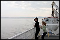 Woman and girl looking out from deck of ferry. Vancouver Island, British Columbia, Canada