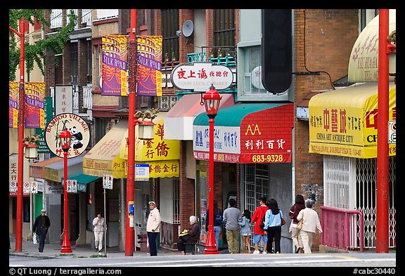 Street in Chinatown with red lamp posts and Chinese characters. Vancouver, British Columbia, Canada