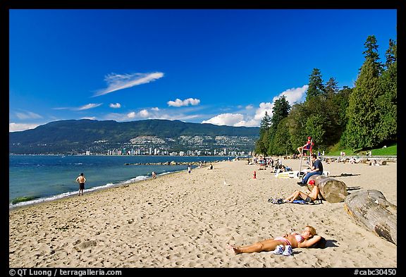 Woman sunning herself on a beach, Stanley Park. Vancouver, British Columbia, Canada (color)