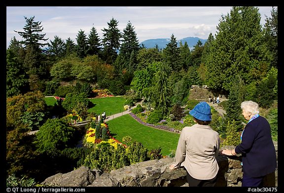 Elderly couple looking at the Sunken Garden in Queen Elizabeth Park. Vancouver, British Columbia, Canada