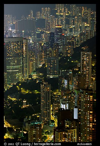 Residential towers on steep hillside from Victoria Peak by night. Hong-Kong, China (color)