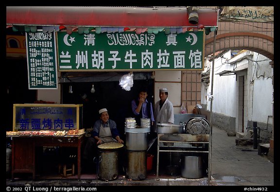 Muslim cooks at restaurant storefront. Kunming, Yunnan, China (color)