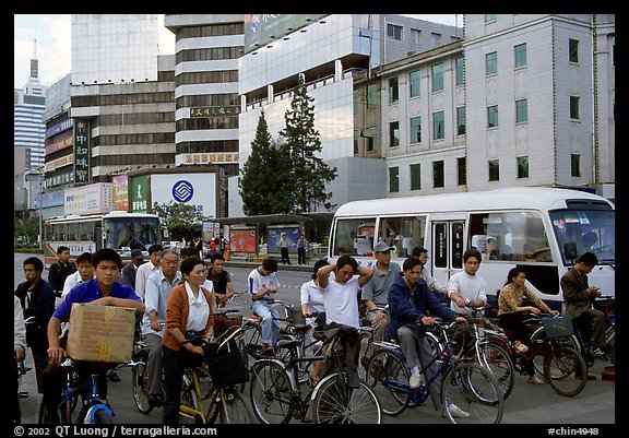 Bicyclists waiting for traffic light. Kunming, Yunnan, China (color)