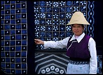 Woman in Bai dress showing drapes of traditional design. Dali, Yunnan, China (color)