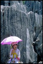 Woman from the Sani branch of the Yi tribespeople with a sun unbrella at the Stone Forest. Shilin, Yunnan, China ( color)