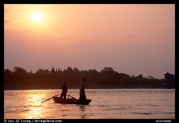 Fishermen at the confluence of the Dadu He and Min He rivers at sunset. Leshan, Sichuan, China (color)