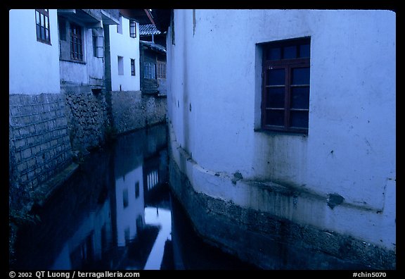 White walled houses surrounding a canal. Lijiang, Yunnan, China
