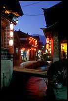 Streets, bridge, wooden houses, red lanterns and canal. Lijiang, Yunnan, China