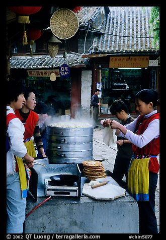 Naxi women selling dumplings and Naxi baba flatbread. Lijiang, Yunnan, China (color)