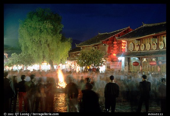 Celebration around a fire in Square Street by night. Lijiang, Yunnan, China
