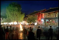 Celebration around a fire in Square Street by night. Lijiang, Yunnan, China (color)