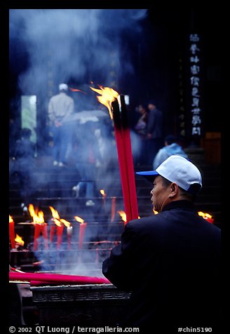 Pilgrim offering big incense stick. Emei Shan, Sichuan, China