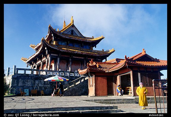 Monk walking in front of Jinding Si temple. Emei Shan, Sichuan, China