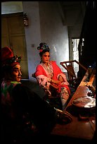 Sichuan opera actors getting ready in the backstage before the performance. Chengdu, Sichuan, China (color)