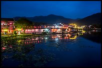 Hongcun village reflected in South Lake at night. Hongcun Village, Anhui, China