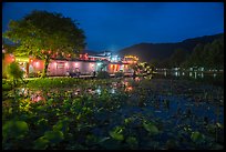 Houses reflected in South Lake at night. Hongcun Village, Anhui, China