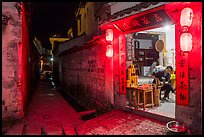 Shopkeeper and alley at night. Hongcun Village, Anhui, China ( color)