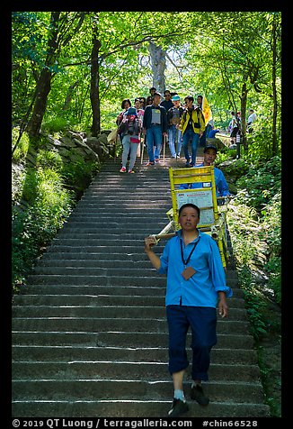 Sedan chair carriers on steep staircase. Huangshan Mountain, China (color)