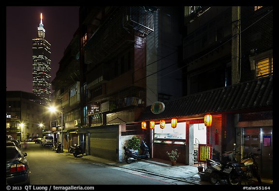 Dark street, store with lanters, and Taipei 101. Taipei, Taiwan