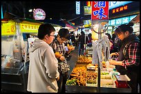 Customer buying foods at Shilin Night Market. Taipei, Taiwan (color)