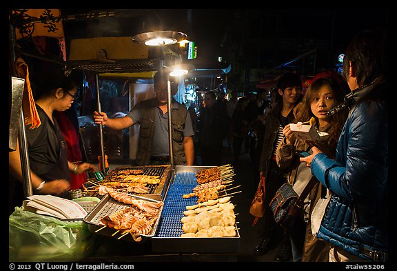 Sampling snacks at Shilin Night Market. Taipei, Taiwan