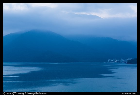 Itashao Village and cloud-shrounded mountains at dawn. Sun Moon Lake, Taiwan (color)