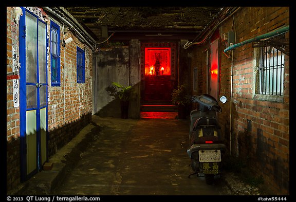 Alley at night with temple altar glowing red. Lukang, Taiwan (color)