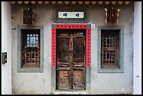 Facade of concrete building with wooden doors and windows. Lukang, Taiwan (color)
