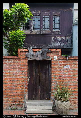 Brick wall and historic wooden house. Lukang, Taiwan (color)