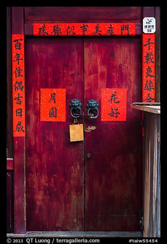 Wooden door traditional lock and chinese inscription on red paper. Lukang, Taiwan
