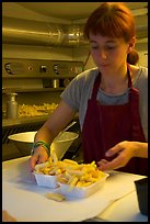 Woman serving fries in a booth. Bruges, Belgium (color)