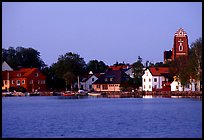 Houses, church, across the lake at dusk, Vadstena. Gotaland, Sweden (color)